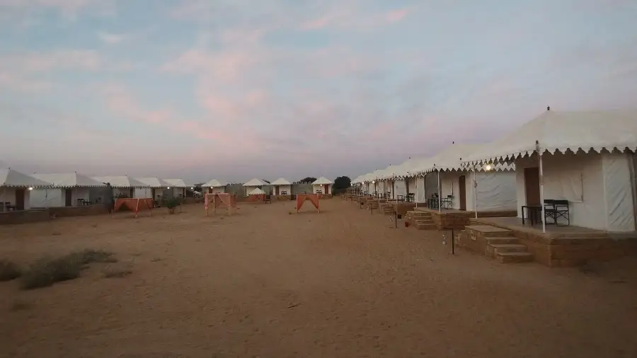 Row of Swiss tents at a Jaisalmer desert camp at dusk near the Sam sand dunes.